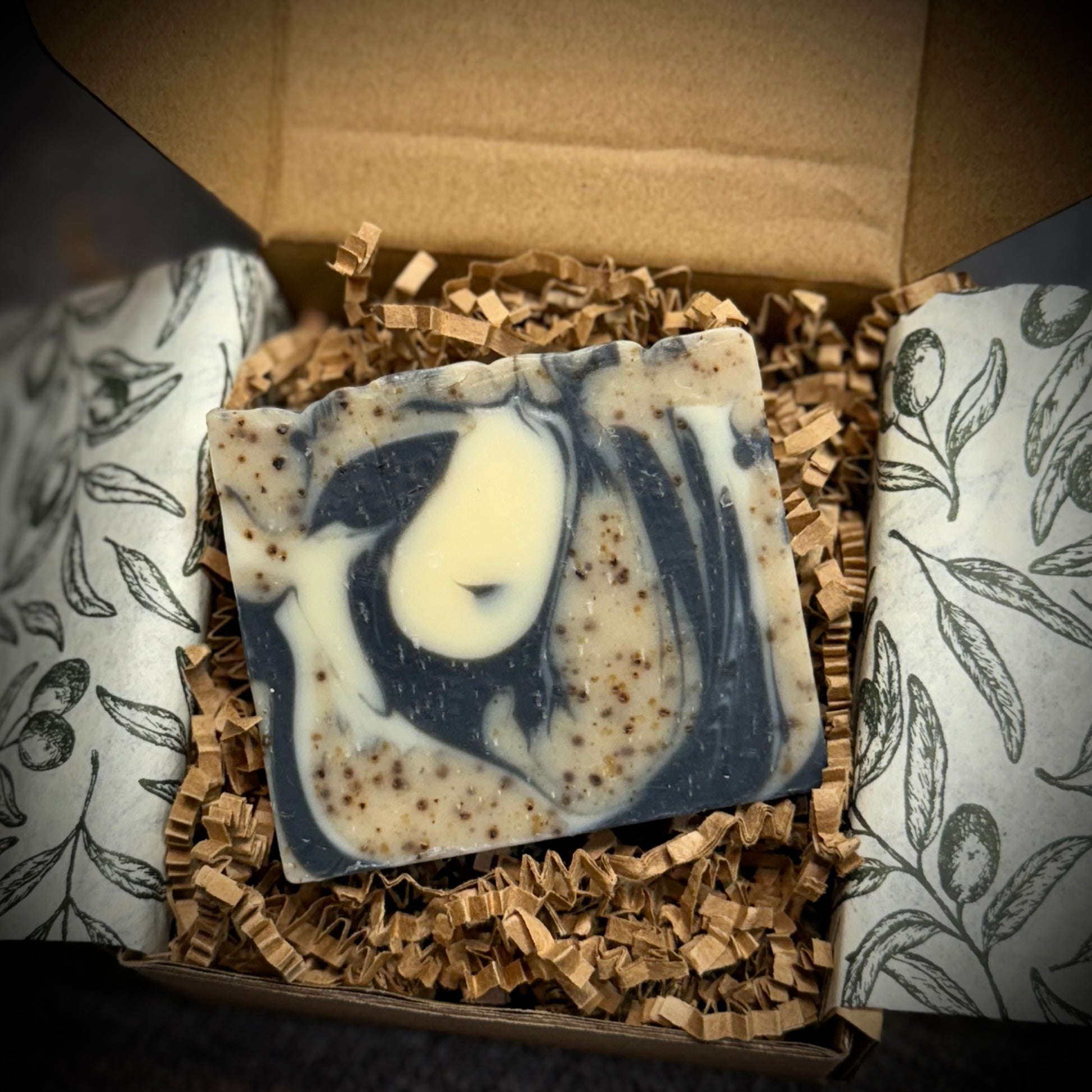 Marbled soap bar in a decorative box with patterned paper
