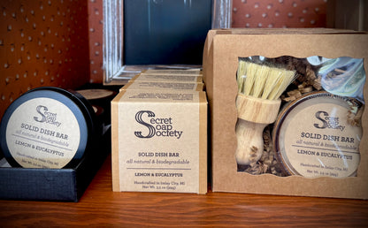 Solid dish bars from The Secret Soap Society on a wooden surface